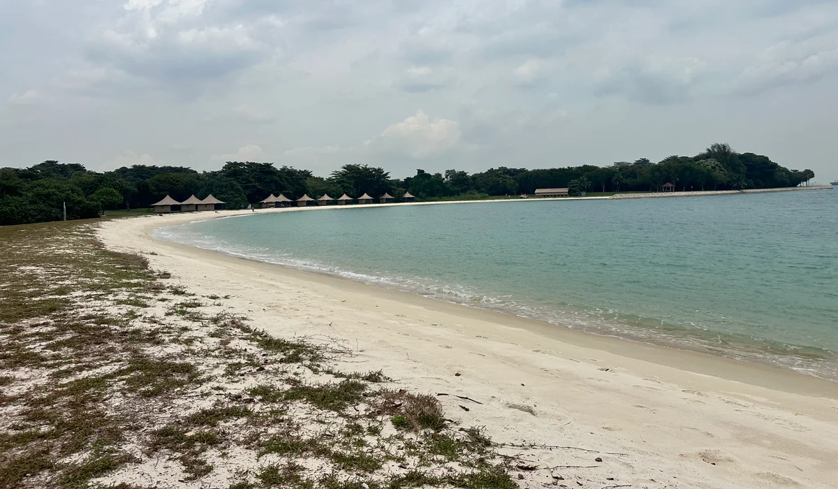 Lazarus Island — empty beach, the Singapore skyline visible across the water