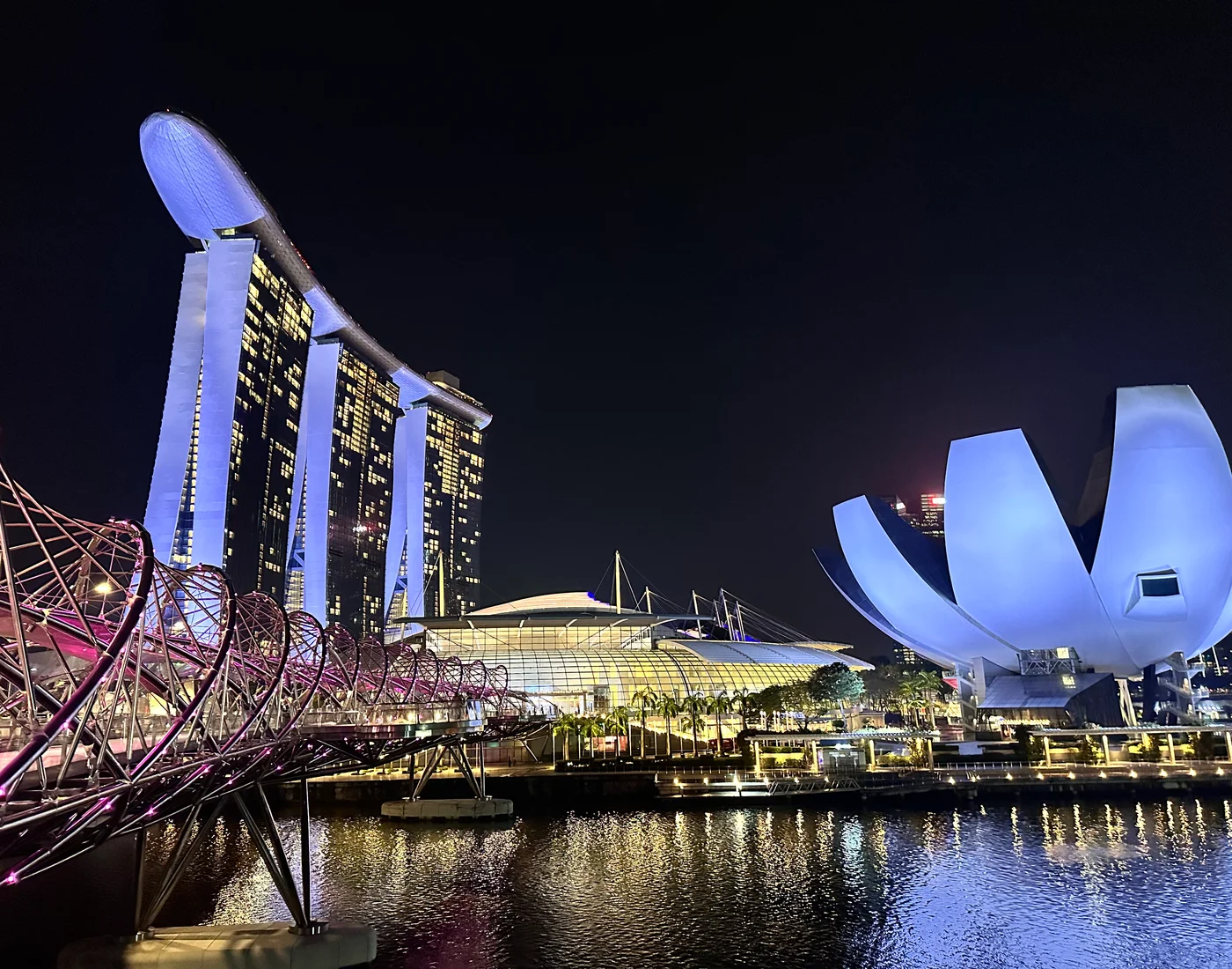 Marina Bay Sands at night with the Supertrees in cool blues