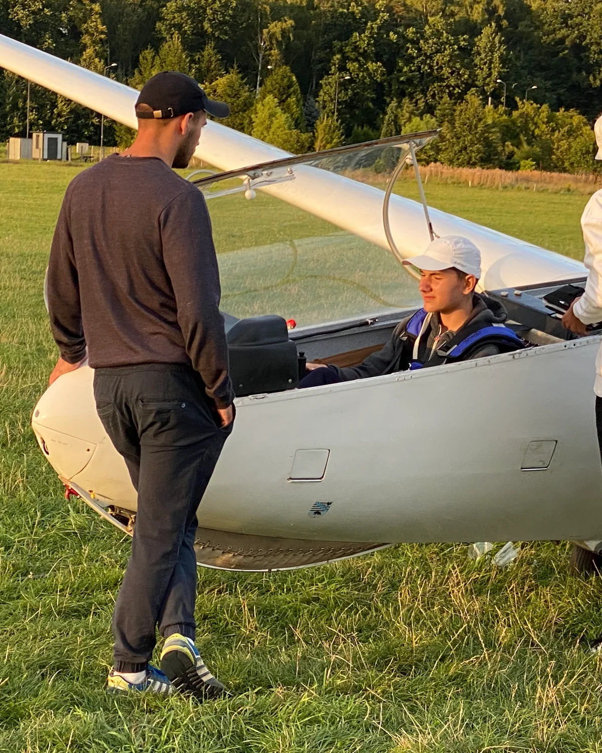 The user at fourteen, in the cockpit, on first solo. Awkward, ungroomed, before any of the credentials.